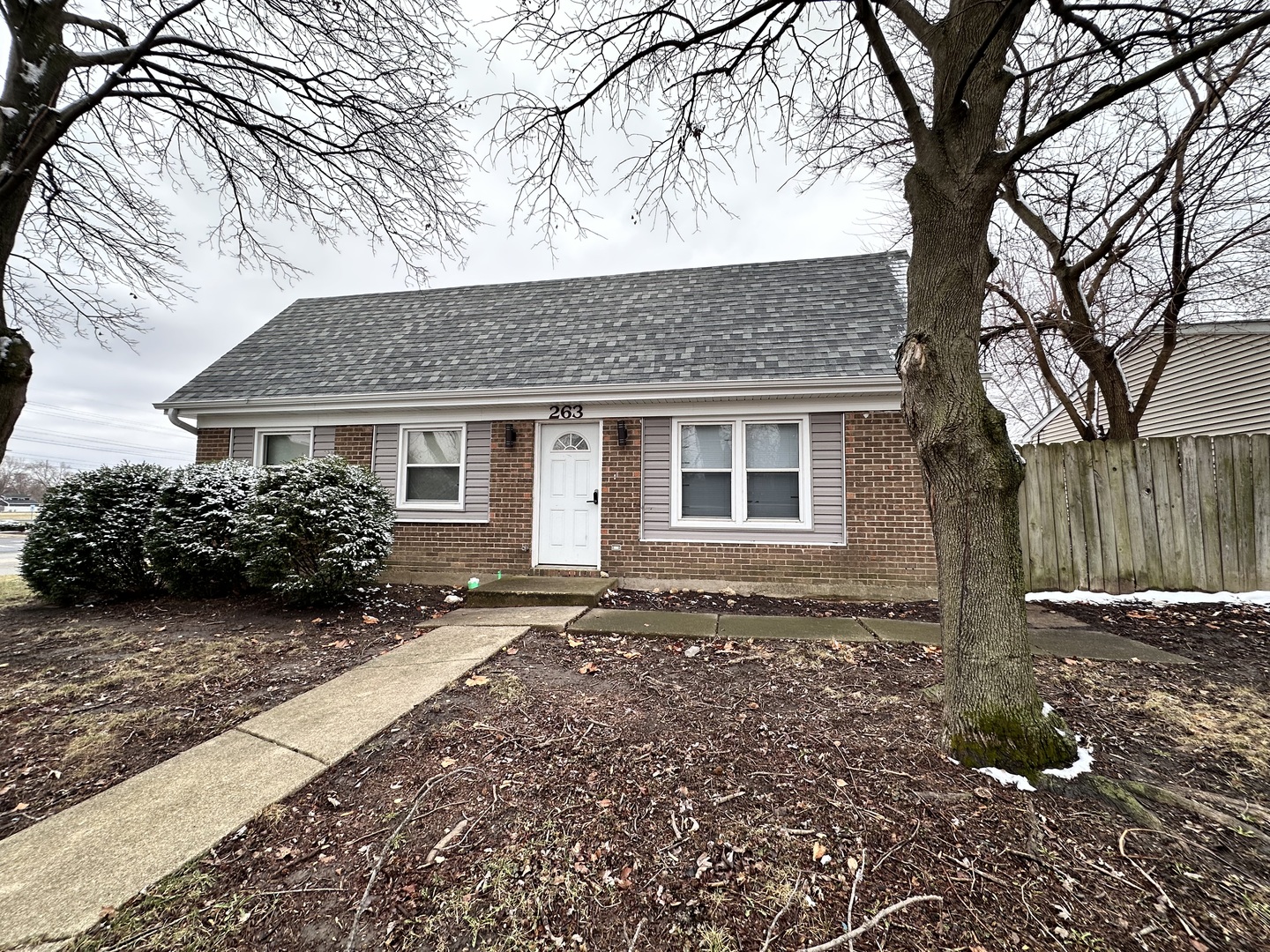 a front view of a house with a garden