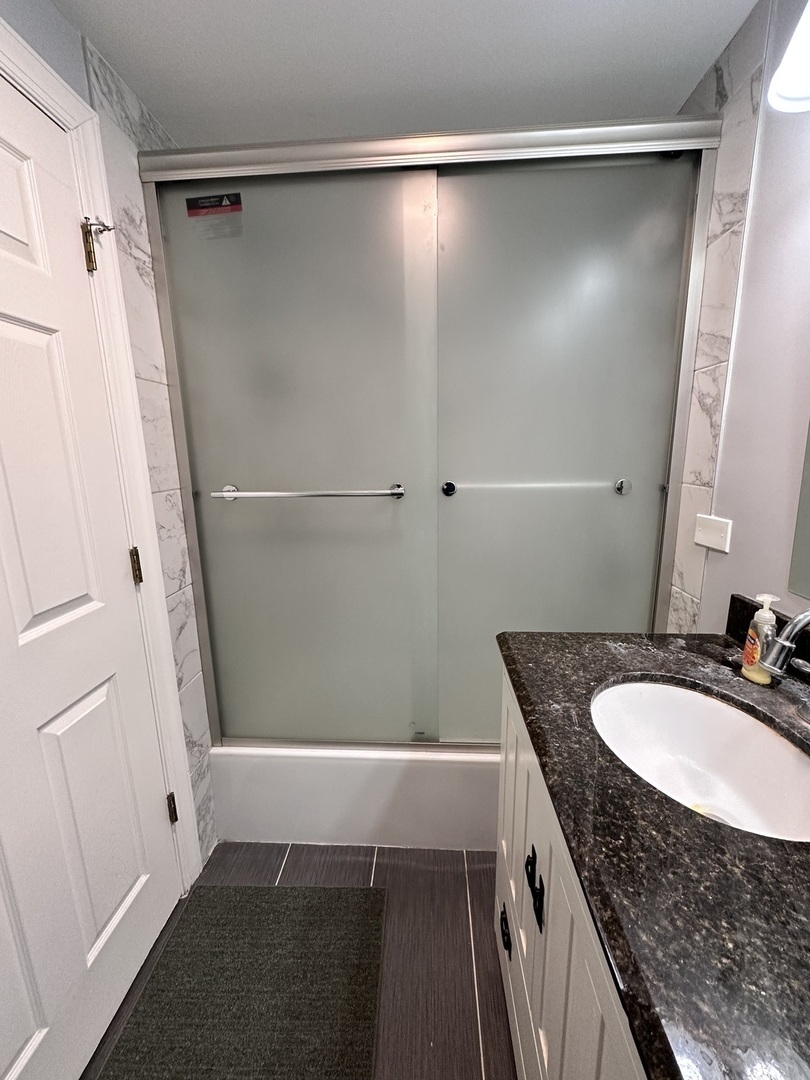 263 Blackberry Drive Bolingbrook, IL 60440 - Photo 29 of 50 a bathroom with a granite countertop sink and shower