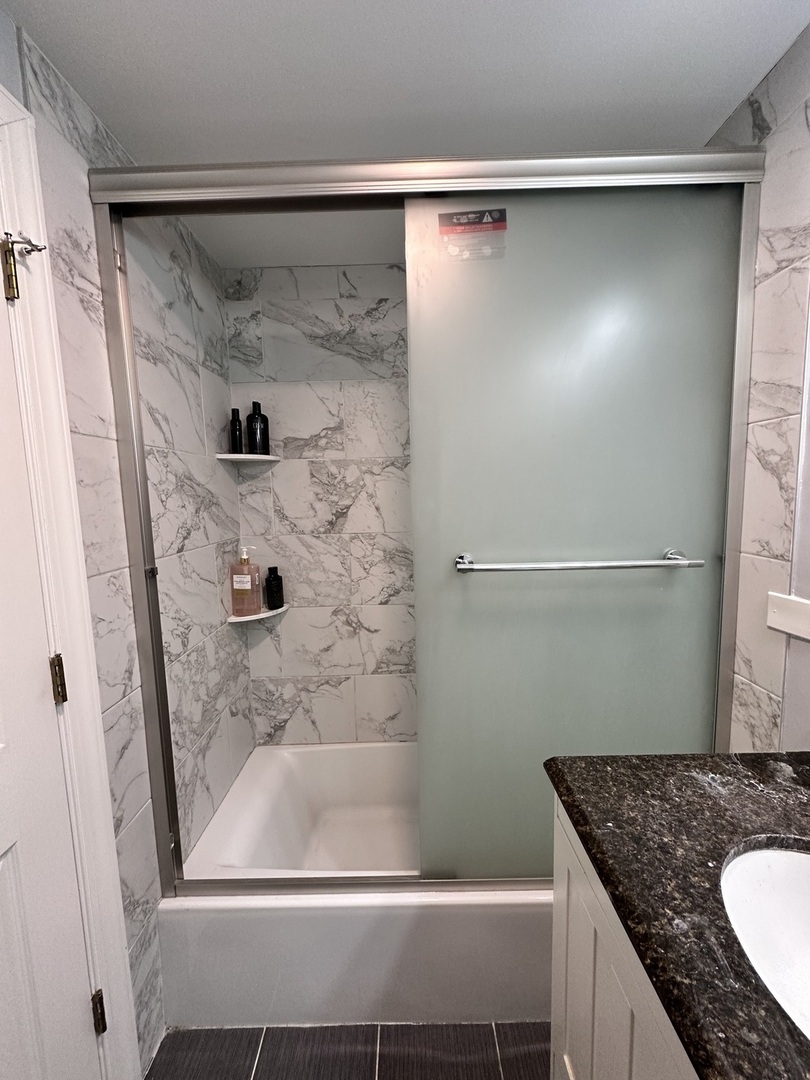 263 Blackberry Drive Bolingbrook, IL 60440 - Photo 30 of 50 a bathroom with a granite countertop shower and a sink