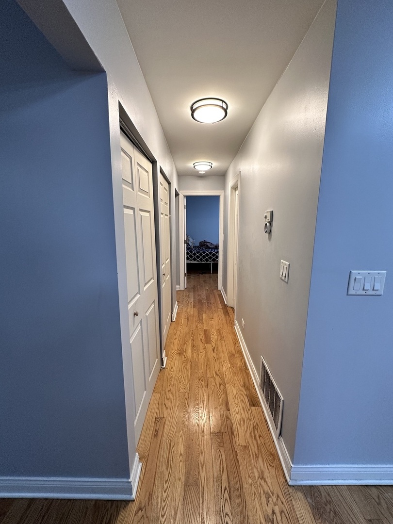 263 Blackberry Drive Bolingbrook, IL 60440 - Photo 7 of 50 a view of a hallway with wooden floor and furniture
