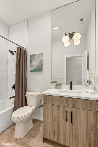 a bathroom with a double vanity sink mirror and toilet