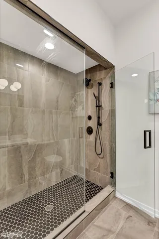 a bathroom with a glass shower door