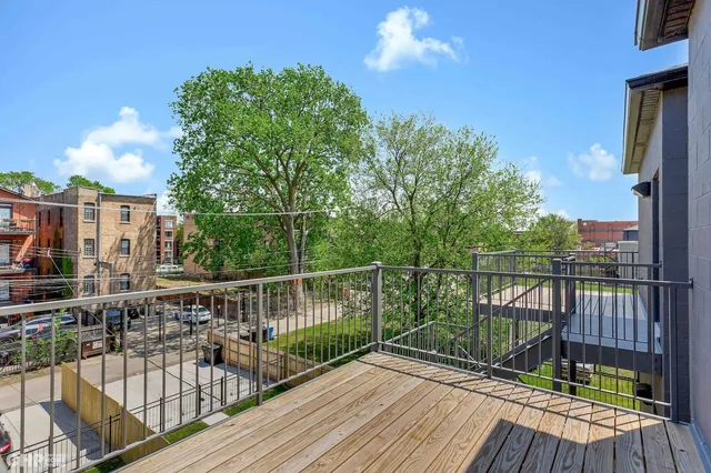 a view of a balcony with wooden floor and city view