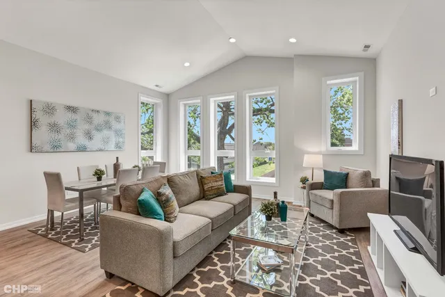 a living room with furniture and large windows