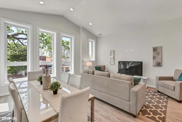a living room with furniture and large windows