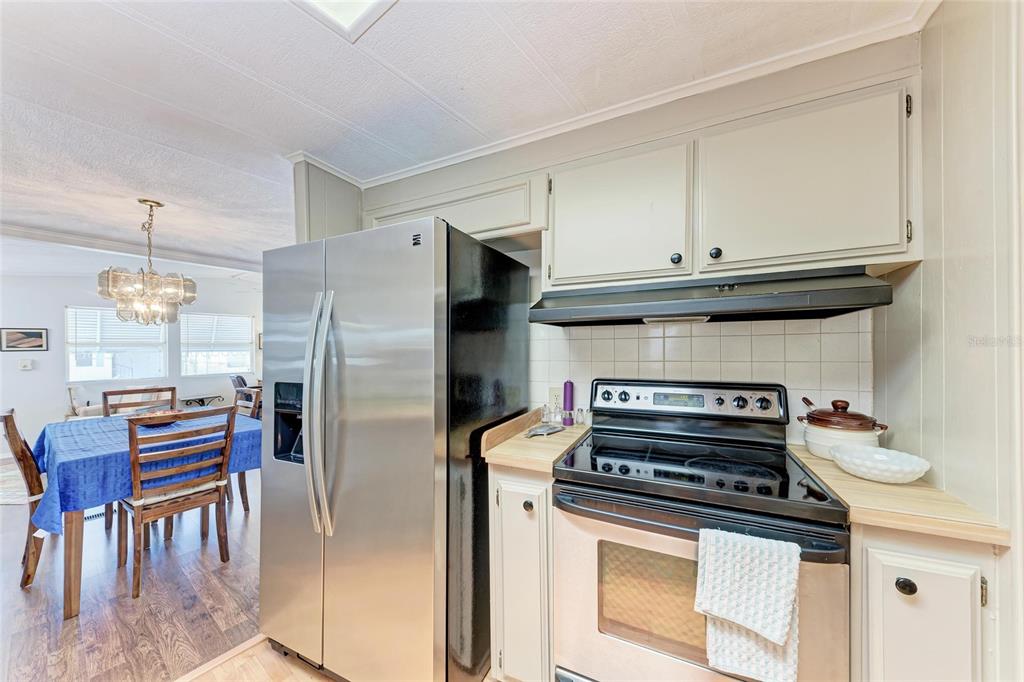 5619 Bayshore Road, Unit 164 Palmetto, FL 34221 - Photo 13 of 42 a kitchen with stainless steel appliances granite countertop a stove a refrigerator and a refrigerator