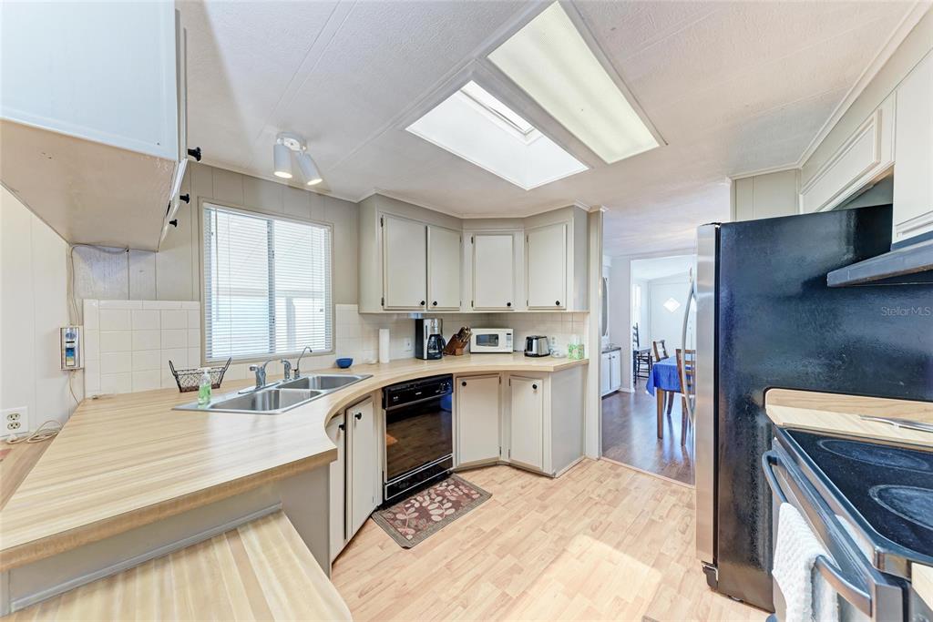 5619 Bayshore Road, Unit 164 Palmetto, FL 34221 - Photo 14 of 42 a kitchen with a sink stove and refrigerator
