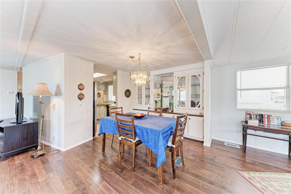 5619 Bayshore Road, Unit 164 Palmetto, FL 34221 - Photo 17 of 42 a view of a dining room with furniture and wooden floor