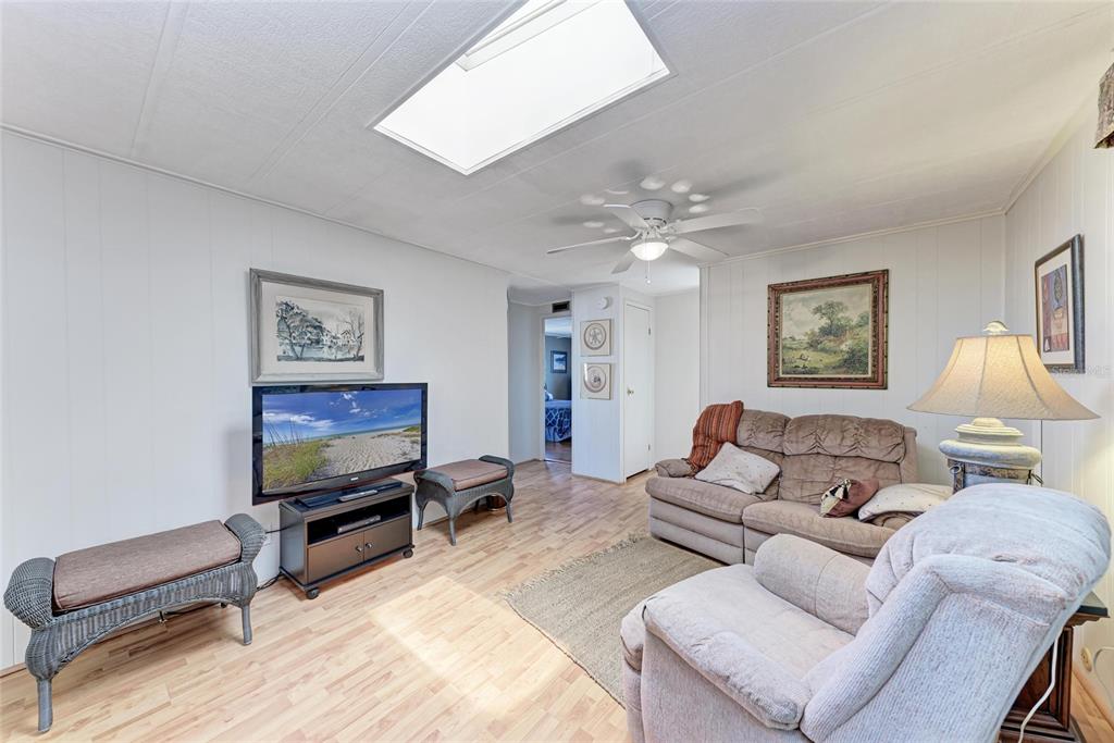 5619 Bayshore Road, Unit 164 Palmetto, FL 34221 - Photo 19 of 42 a living room with furniture a flat screen tv and a lamp