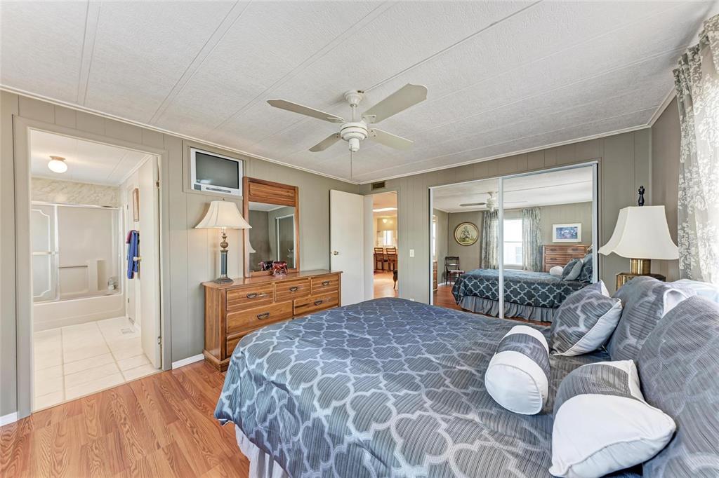 5619 Bayshore Road, Unit 164 Palmetto, FL 34221 - Photo 23 of 42 a bedroom with a large bed and ceiling fan