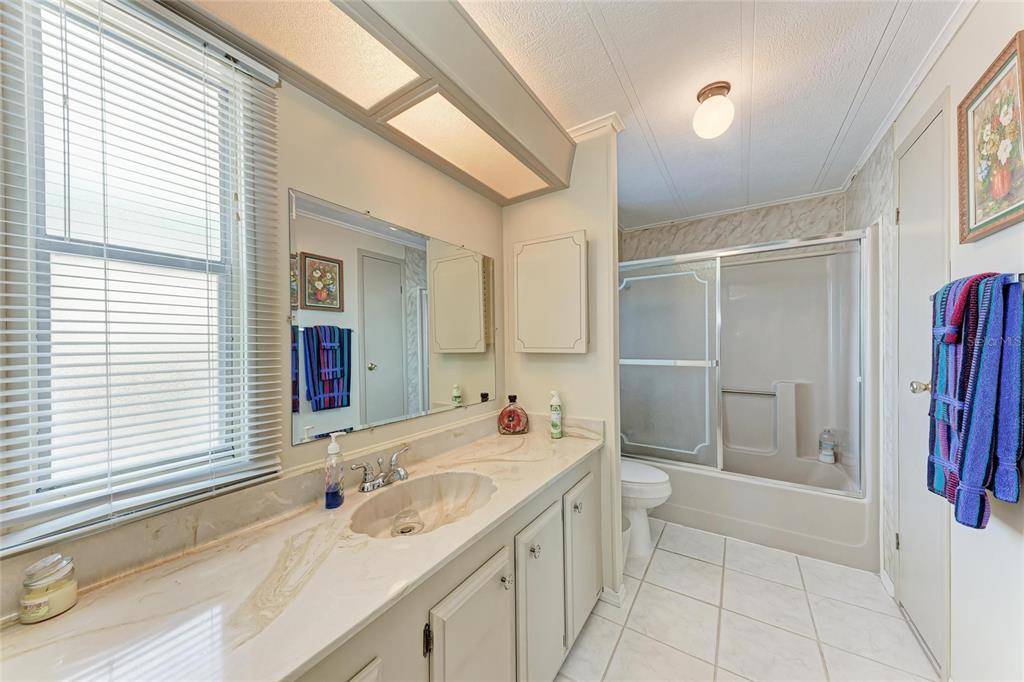 5619 Bayshore Road, Unit 164 Palmetto, FL 34221 - Photo 25 of 42 a bathroom with a sink a toilet and shower
