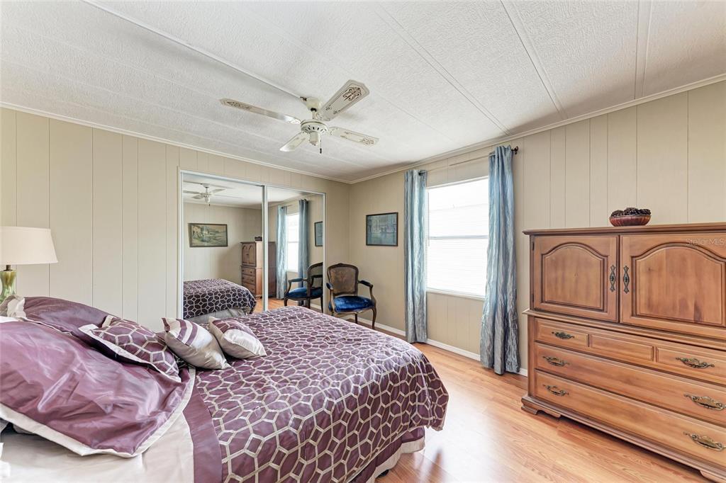 5619 Bayshore Road, Unit 164 Palmetto, FL 34221 - Photo 26 of 42 a bedroom with a bed and wooden floor