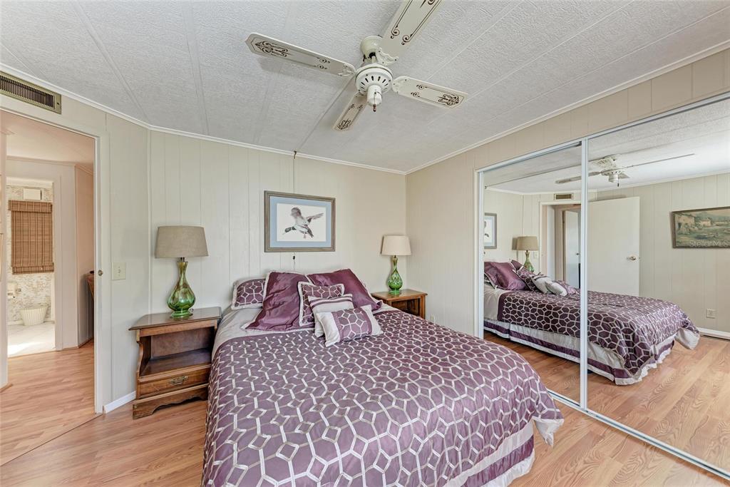 5619 Bayshore Road, Unit 164 Palmetto, FL 34221 - Photo 27 of 42 a bedroom with a bed and wooden floor