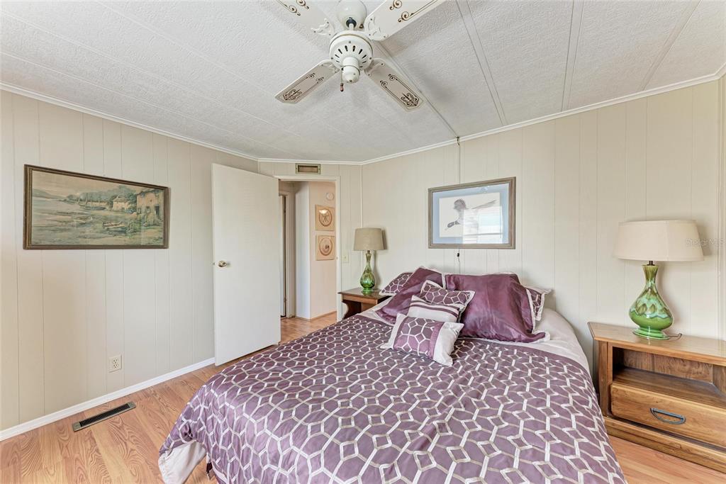 5619 Bayshore Road, Unit 164 Palmetto, FL 34221 - Photo 28 of 42 a bedroom with a large bed and a chandelier