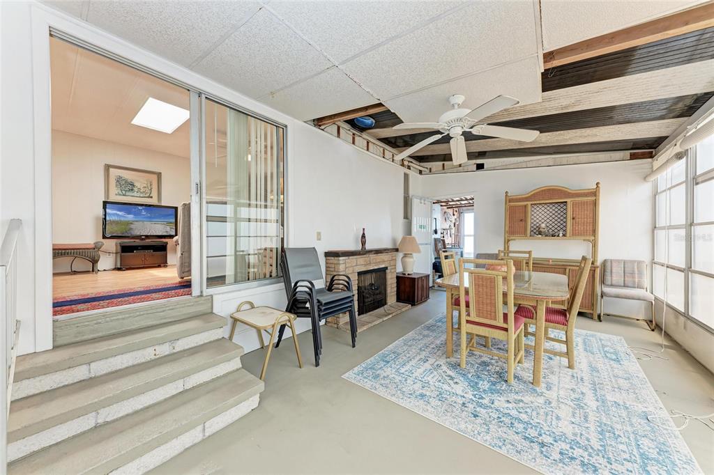 5619 Bayshore Road, Unit 164 Palmetto, FL 34221 - Photo 30 of 42 a dining room with furniture a rug and a fireplace