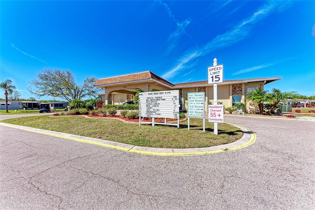 5619 Bayshore Road, Unit 164 Palmetto, FL 34221 - Photo 39 of 42 a front view of a house with a yard and trees