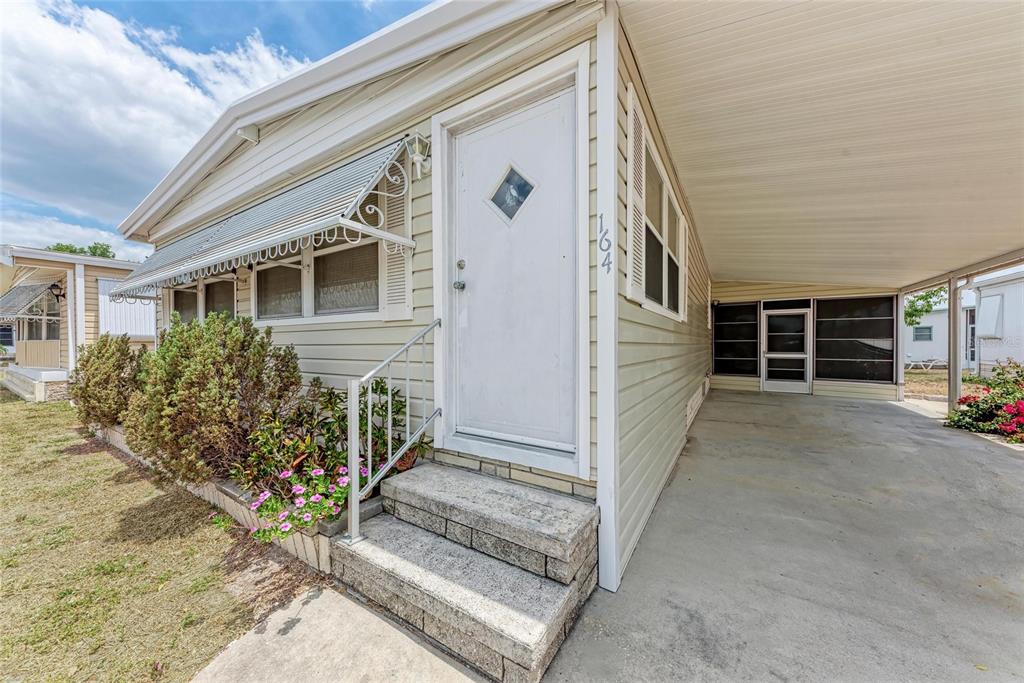 5619 Bayshore Road, Unit 164 Palmetto, FL 34221 - Photo 4 of 42 a front view of a house with a garage