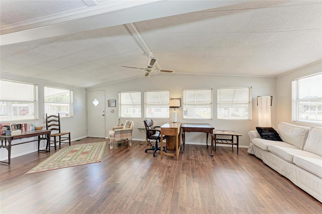 5619 Bayshore Road, Unit 164 Palmetto, FL 34221 - Photo 5 of 42 a living room with furniture and a wooden floor
