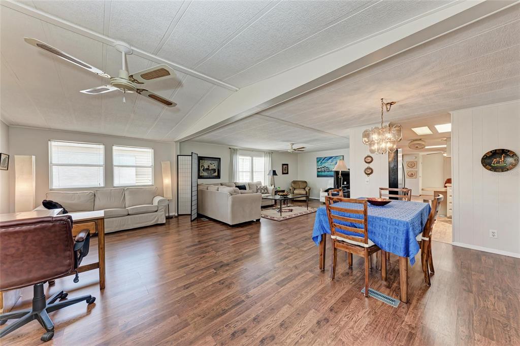 5619 Bayshore Road, Unit 164 Palmetto, FL 34221 - Photo 6 of 42 a living room with furniture dining table wooden floor and a fireplace