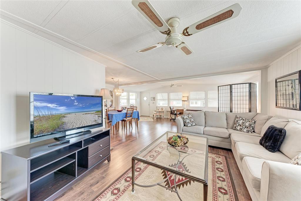 5619 Bayshore Road, Unit 164 Palmetto, FL 34221 - Photo 10 of 42 a living room with furniture and a flat screen tv