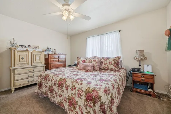 a bedroom with a large bed and a chandelier