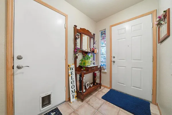 a view of a livingroom with wooden floor and furniture