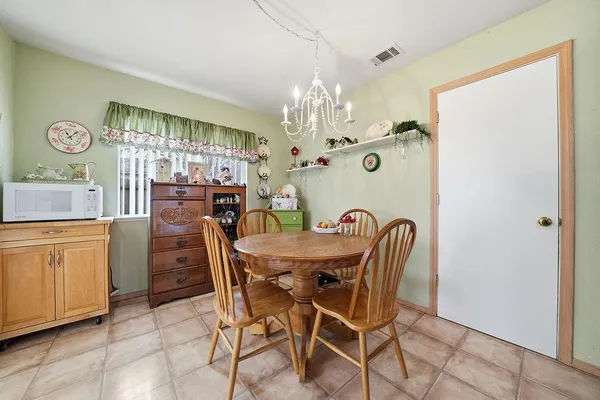 a dining room with furniture and wooden floor