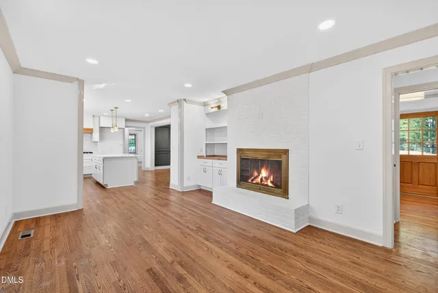 a view of a kitchen with a sink and a fireplace