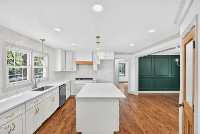 a kitchen with a stove a sink and a refrigerator