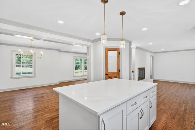 a large kitchen with granite countertop a large window and a sink