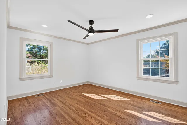 a view of a kitchen with wooden floor and a window