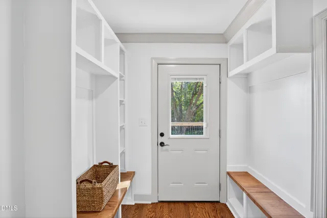 a view of empty room with wooden floor