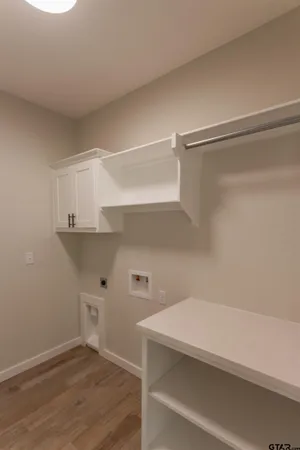 a view of storage and utility room with wooden floor