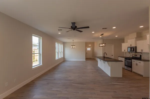 a view of a kitchen with a sink stainless steel appliances and cabinets