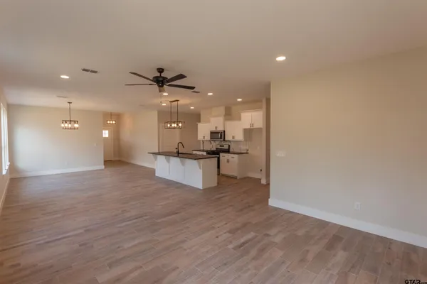 a view of a kitchen with a sink and a refrigerator
