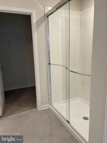 a bathroom with a granite countertop toilet sink and mirror
