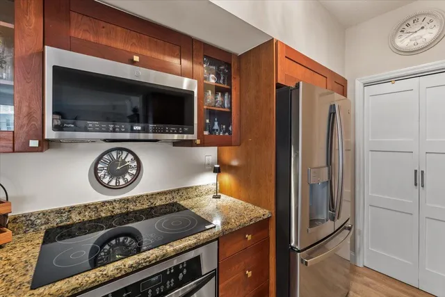 a kitchen with a refrigerator a stove and a microwave