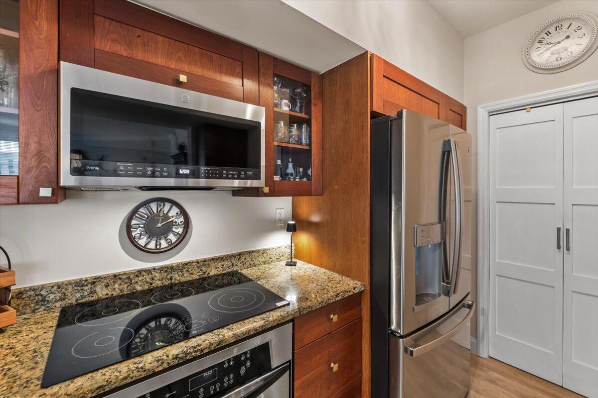 815 Northwest Flagler Avenue, Unit 201 Stuart, FL 34994 - Photo 13 of 43 a kitchen with a refrigerator a stove and a microwave