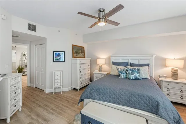 a bedroom with a large bed and a chandelier