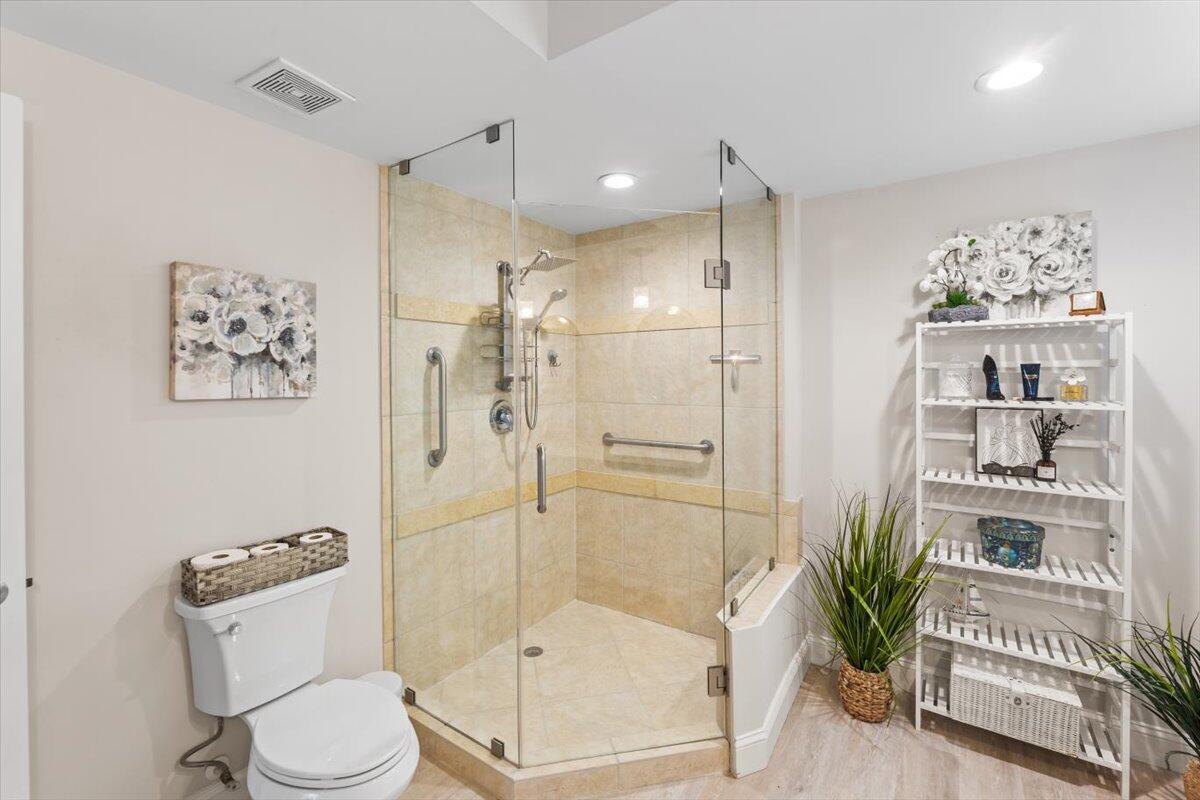 815 Northwest Flagler Avenue, Unit 201 Stuart, FL 34994 - Photo 20 of 43 a bathroom with a shower a toilet and a shower