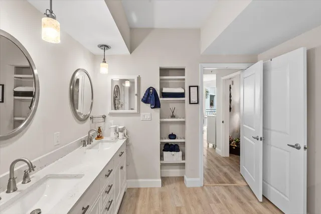 a spacious bathroom with a double vanity sink and a mirror