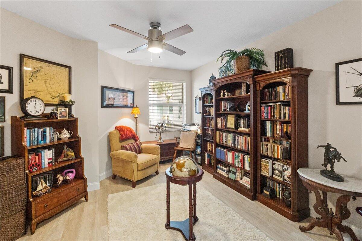 815 Northwest Flagler Avenue, Unit 201 Stuart, FL 34994 - Photo 24 of 43 a bedroom with furniture and a book shelf