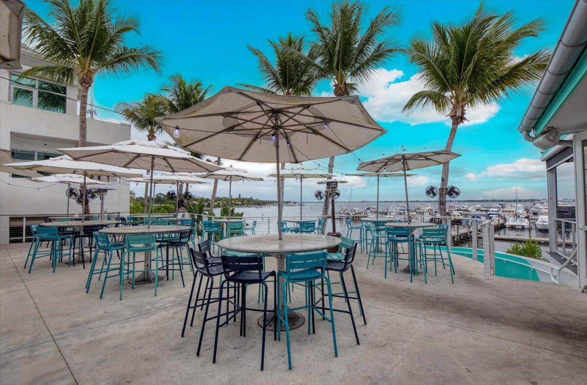 815 Northwest Flagler Avenue, Unit 201 Stuart, FL 34994 - Photo 31 of 43 a view of a dining space with furniture and umbrella