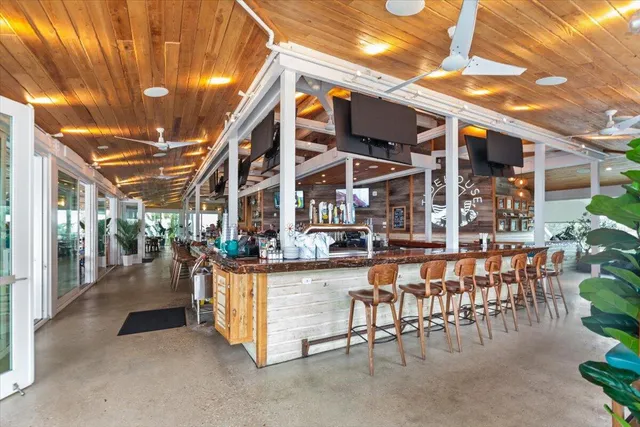 a dining room with lots of furniture and a chandelier