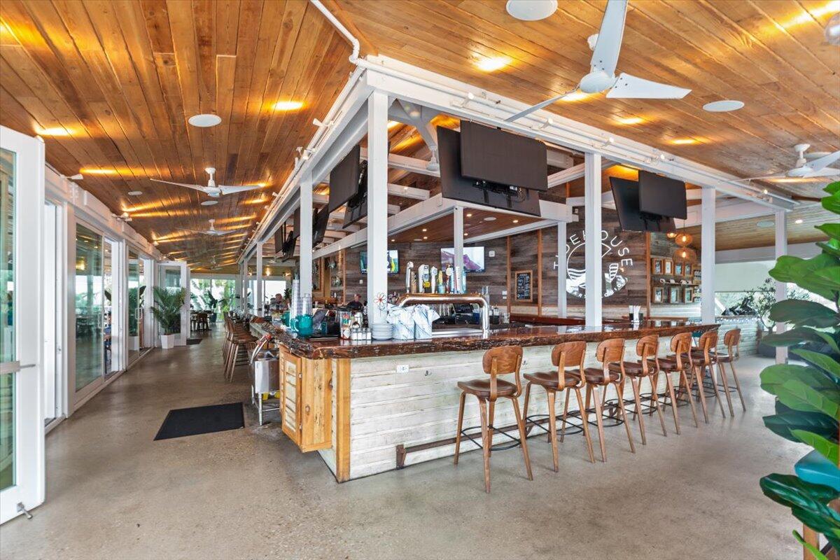 815 Northwest Flagler Avenue, Unit 201 Stuart, FL 34994 - Photo 34 of 43 a view of a patio with dining table and chairs with plants