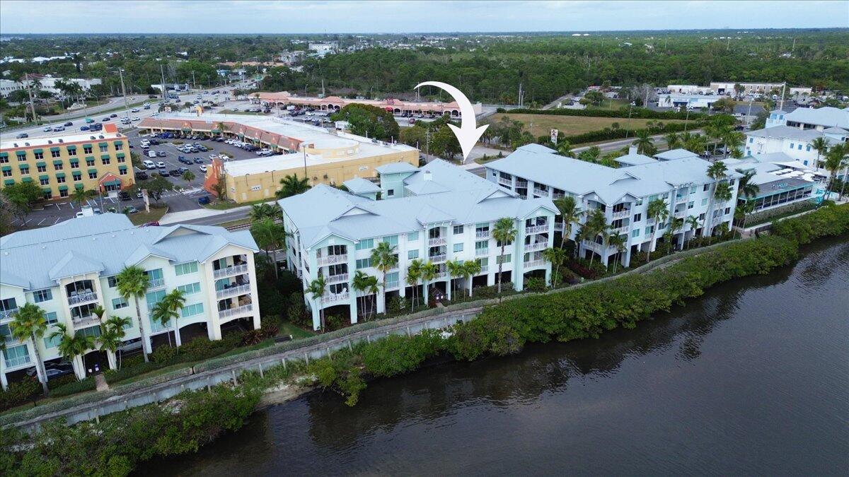 815 Northwest Flagler Avenue, Unit 201 Stuart, FL 34994 - Photo 39 of 43 a view of multiple houses with a lake view