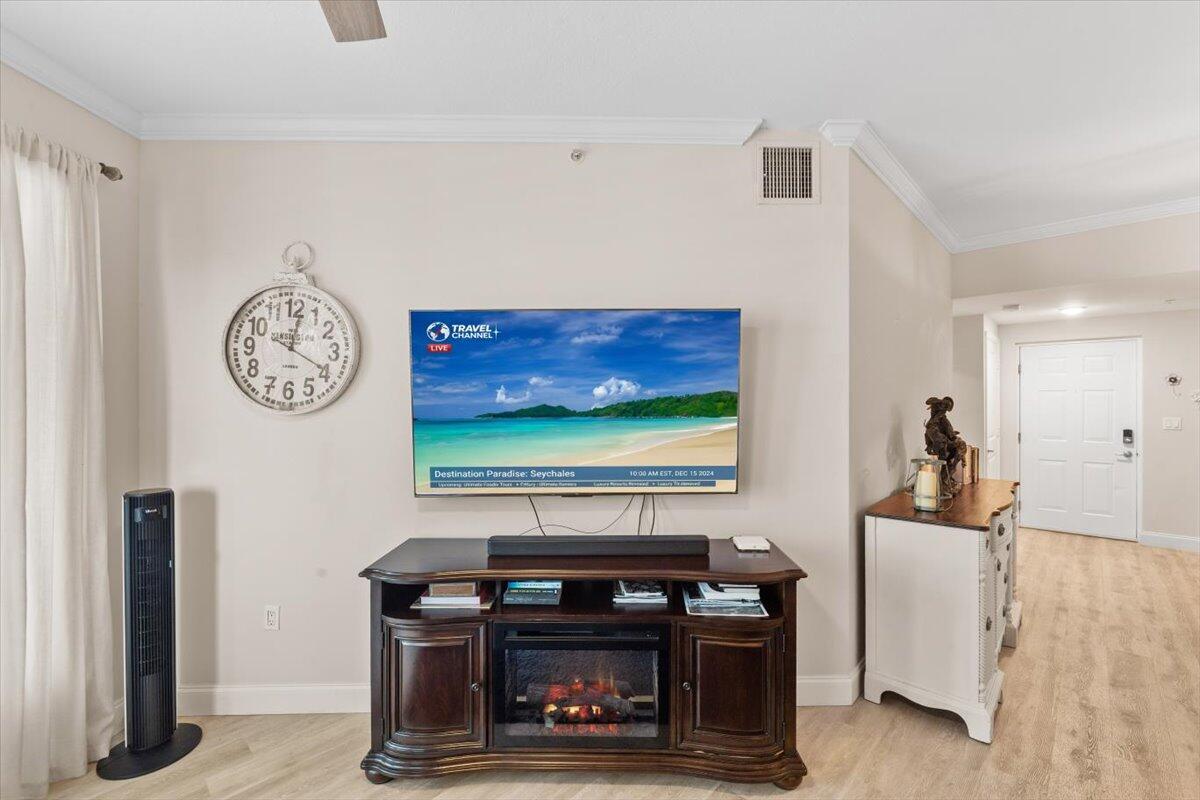 815 Northwest Flagler Avenue, Unit 201 Stuart, FL 34994 - Photo 7 of 43 a room with a stove and a clock