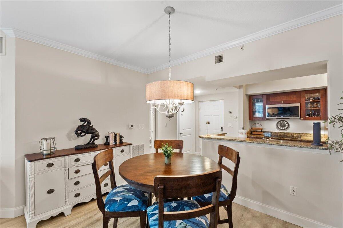 815 Northwest Flagler Avenue, Unit 201 Stuart, FL 34994 - Photo 9 of 43 a dining room with furniture and window