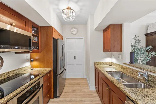 a kitchen with a sink and a stove top oven