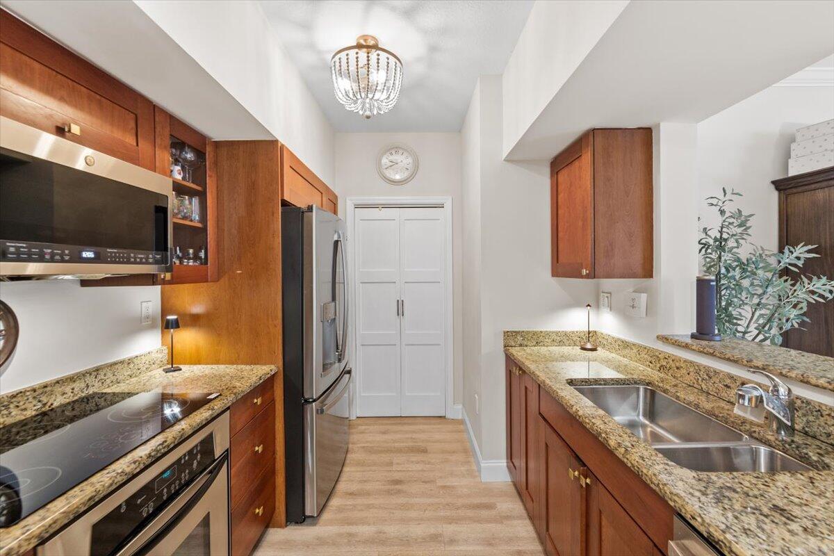 815 Northwest Flagler Avenue, Unit 201 Stuart, FL 34994 - Photo 10 of 43 a kitchen with a sink and a stove top oven
